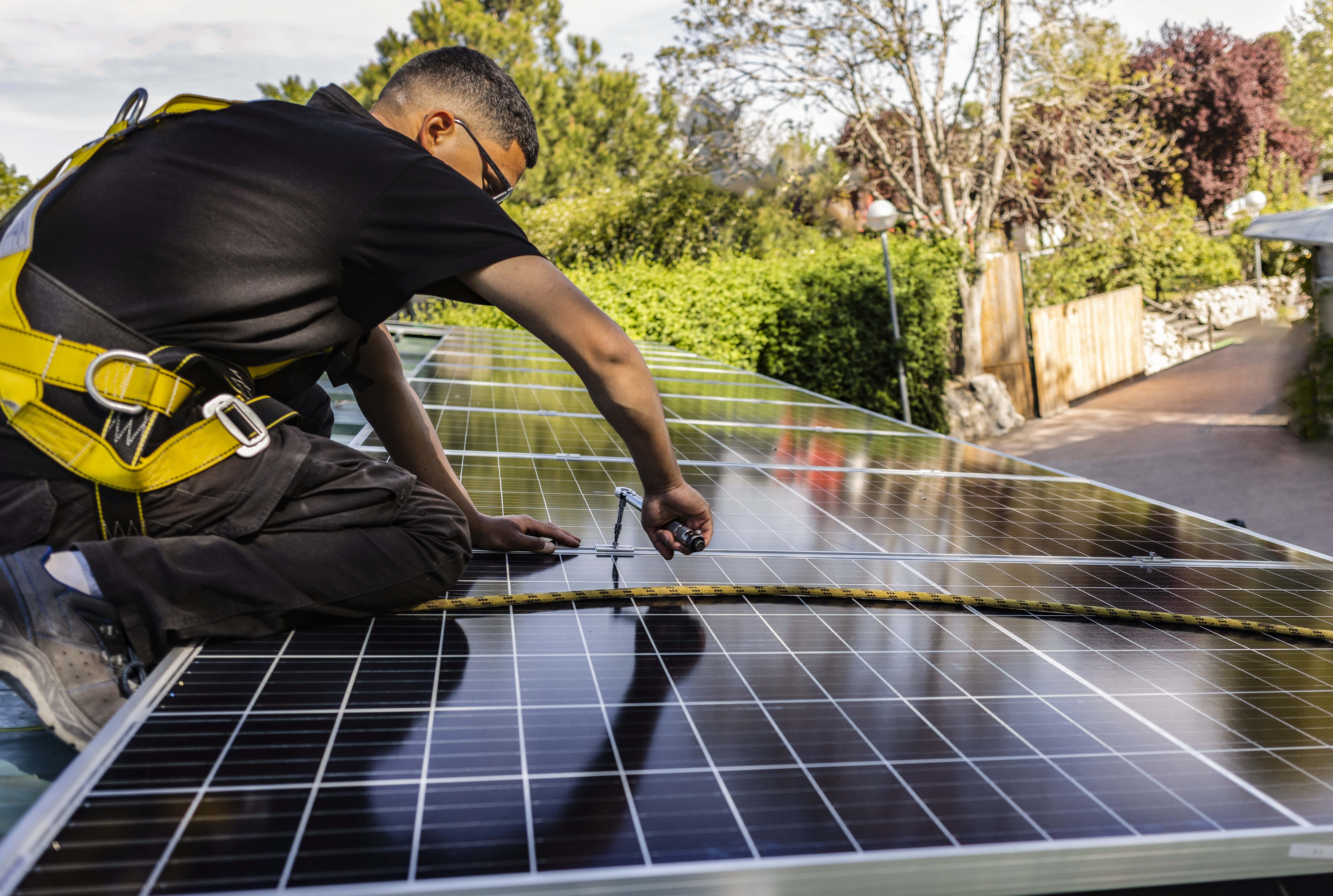 Workers assemble energy system with solar panel for electricity